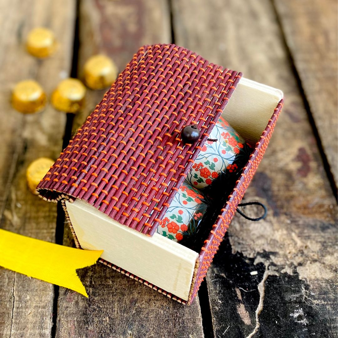 Candles inside Brown gift box with chocolate in background