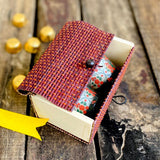 Candles inside Brown gift box with chocolate in background