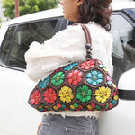 Model holding Multi colour 'Dahlia' coconut handbag
