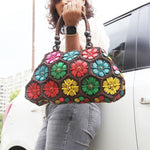 Model holding Multi colour 'Dahlia' coconut handbag