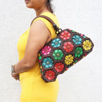 Model holding Multi colour 'Dahlia' coconut handbag