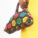 Model holding Multi colour 'Dahlia' coconut handbag