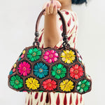 Model holding Multi colour 'Dahlia' coconut handbag