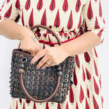 Model holding DaisyLife coconut bags as natural fashion. A beautiful accessory to add to your outfit.