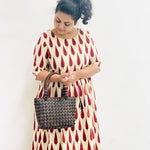 Model holding DaisyLife coconut bags as natural fashion. A beautiful accessory to add to your outfit.