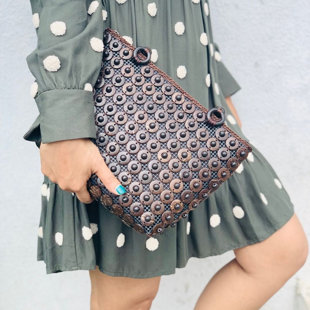 Model holding DaisyLife coconut bags as natural fashion. A beautiful accessory to add to your outfit.