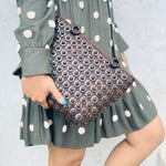 Model holding DaisyLife coconut bags as natural fashion. A beautiful accessory to add to your outfit.