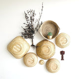 Baskets in different shapes and sizes, a little planter, a palm tree keychain hangar made with bamboo, grass and wood in this installation.