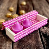 Pink gift box and chocolate kept in background