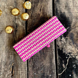 Pink gift box and chocolate kept in background