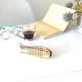 Flat Wooden Fish toy on office table