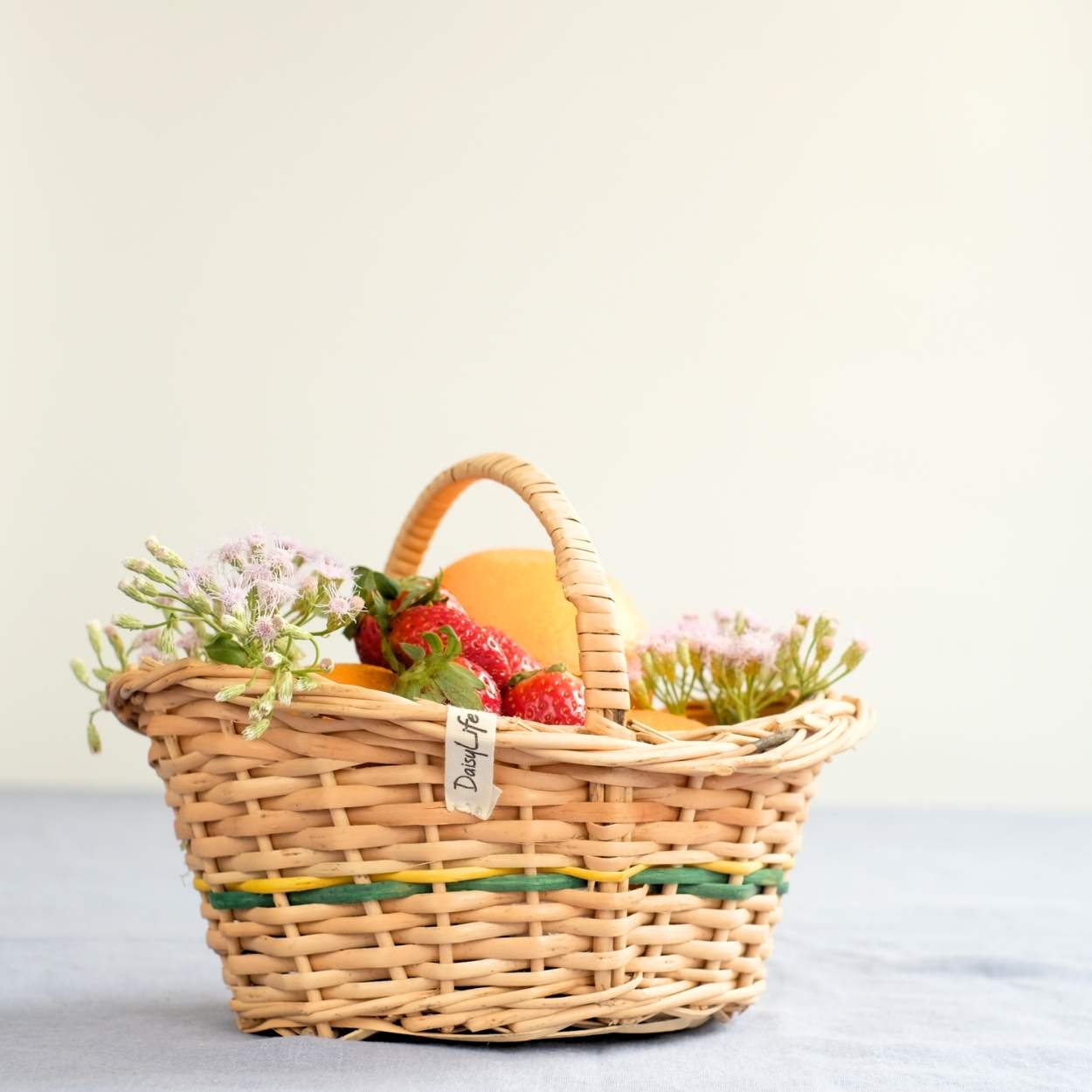 Flower Girl Wicker Basket with flowers and fruits