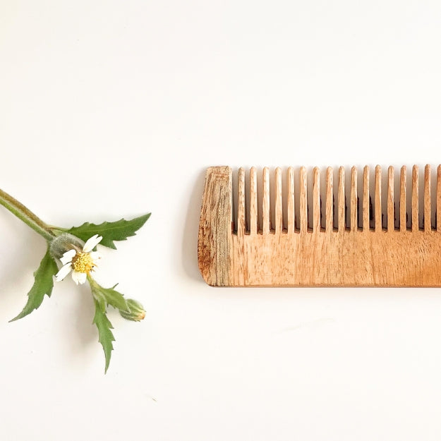 Close up of DaisyLife Small Neem Wooden Comb