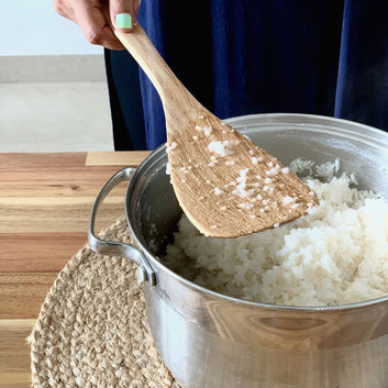 Cooking rice with wooden spoon