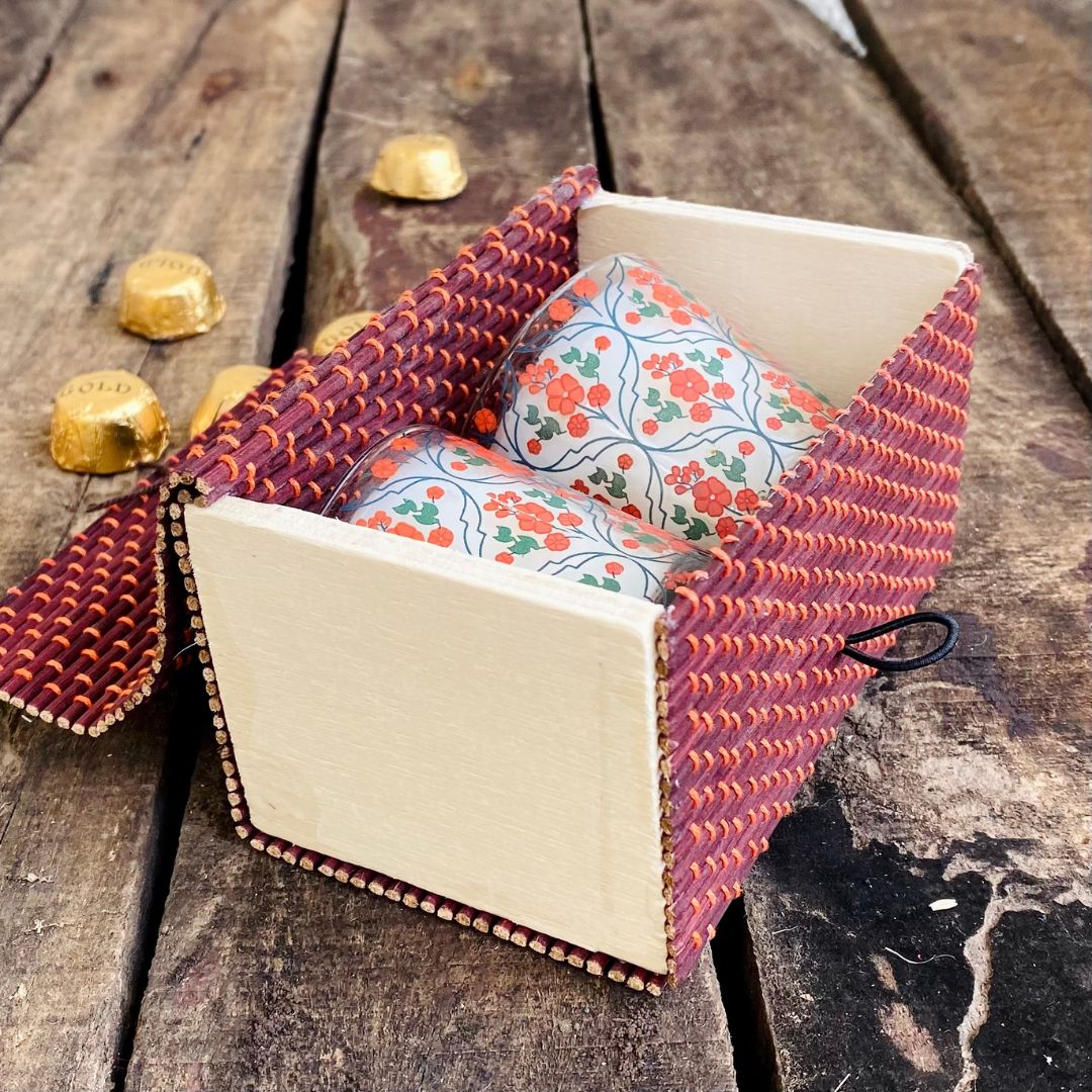 Candles inside Brown gift box with chocolate in background