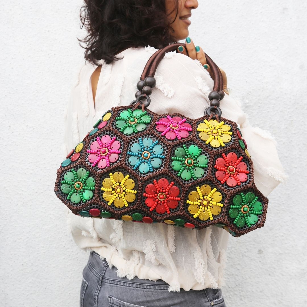 Model holding Multi colour 'Dahlia' coconut handbag