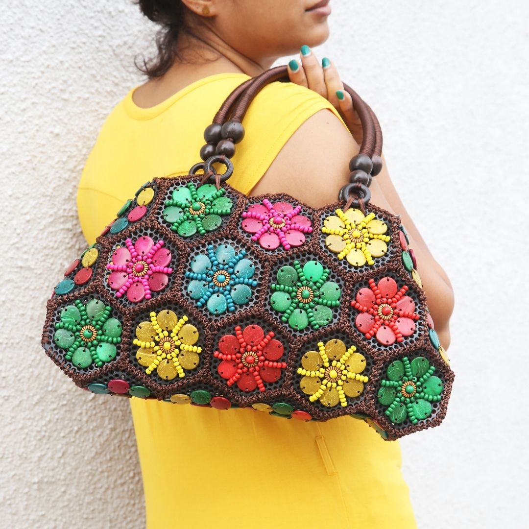 Model holding Multi colour 'Dahlia' coconut handbag