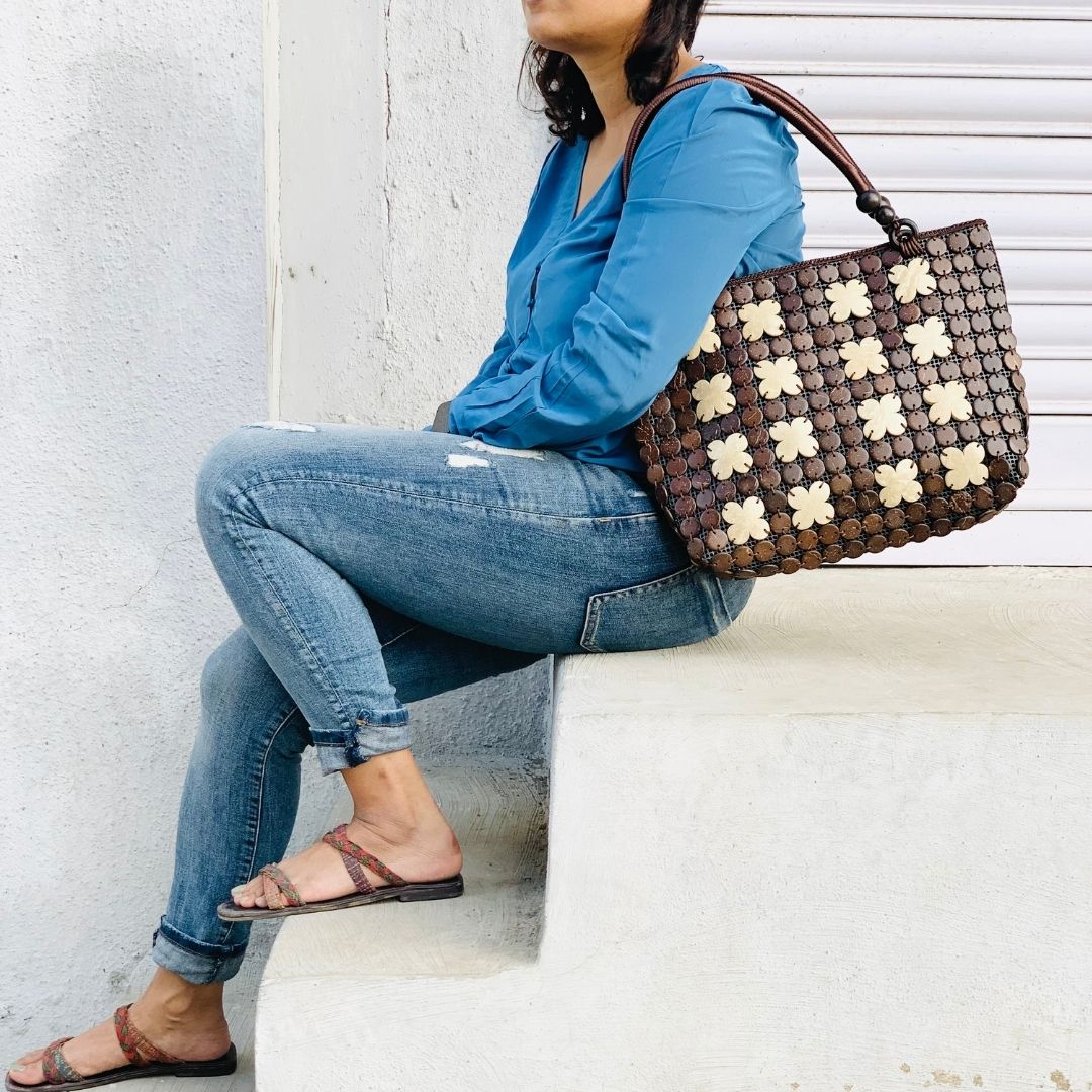 Women carrying natural coconut shell handbag