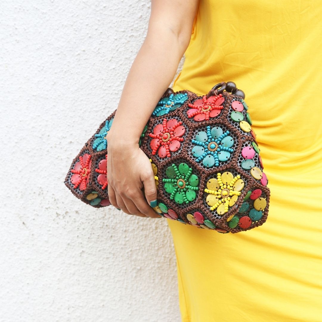 Model holding  Multi colour 'Dahlia' coconut handbag 