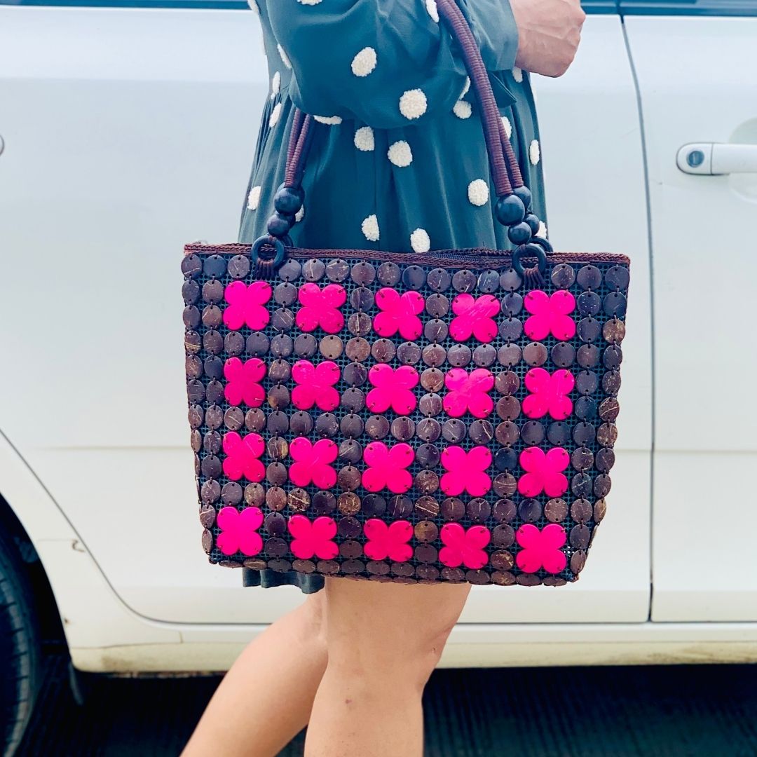 Women carrying natural coconut shell handbag