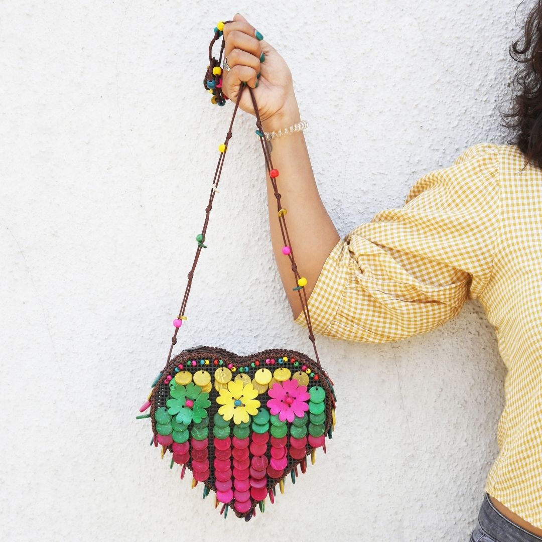 Real coconut shells handcrafted into floral motifs, buttons, discs and cubes with smooth, glowing finish sling bag