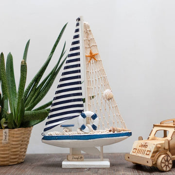 Wooden Natural coral/Seashell ship with blue flag, planter in background