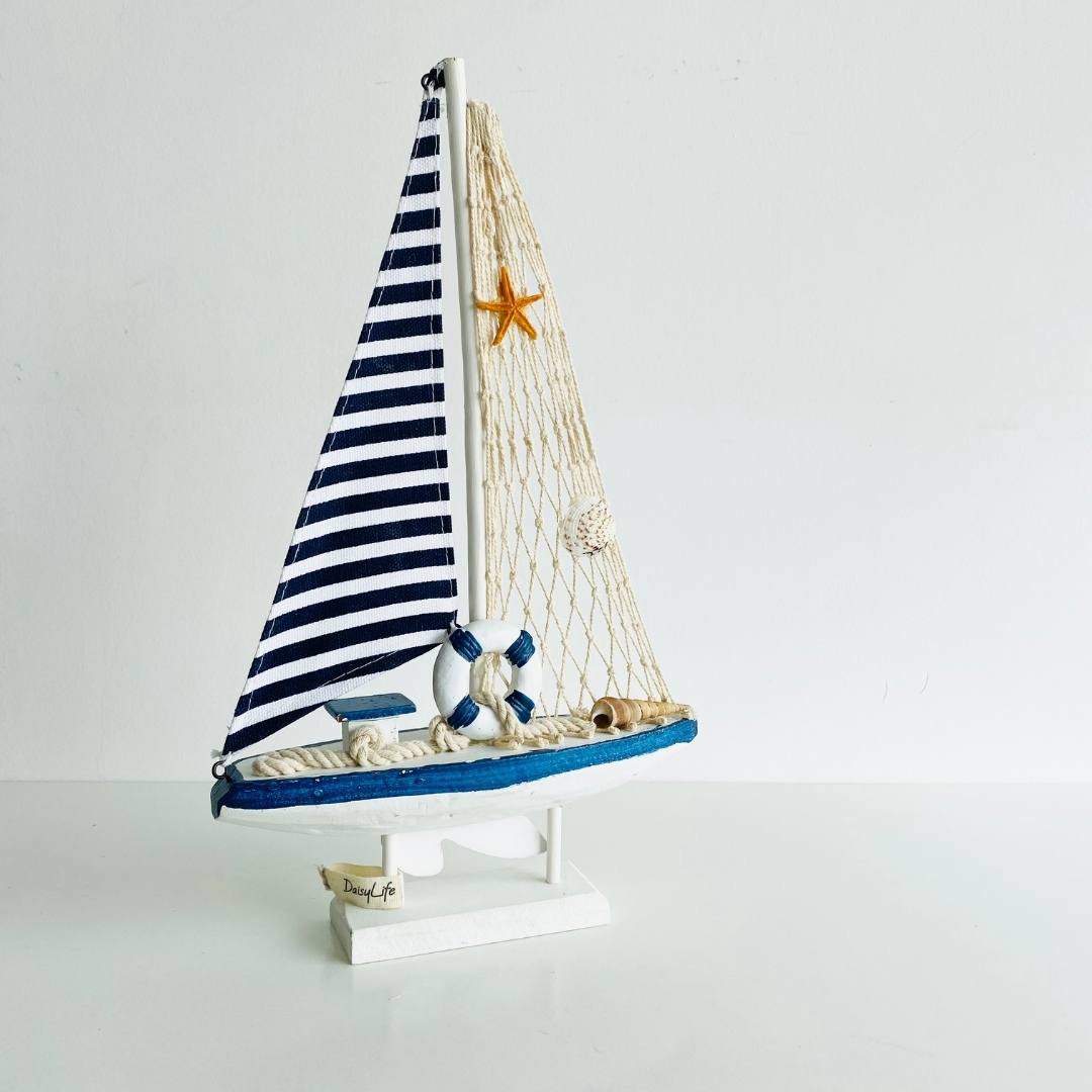 Wooden Natural coral/Seashell ship with blue flag, planter in background