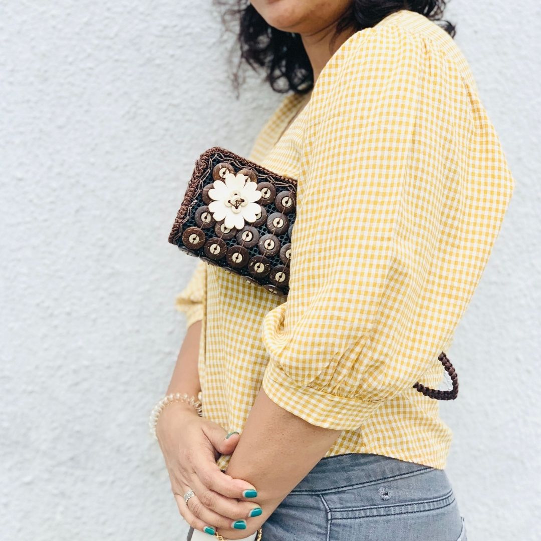 Model holding DaisyLife natural coconut shell 'BB coco' fashion purse