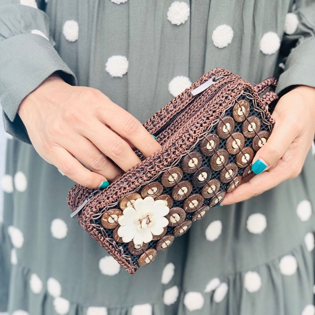 Model holding DaisyLife natural coconut shell 'BB coco' fashion purse