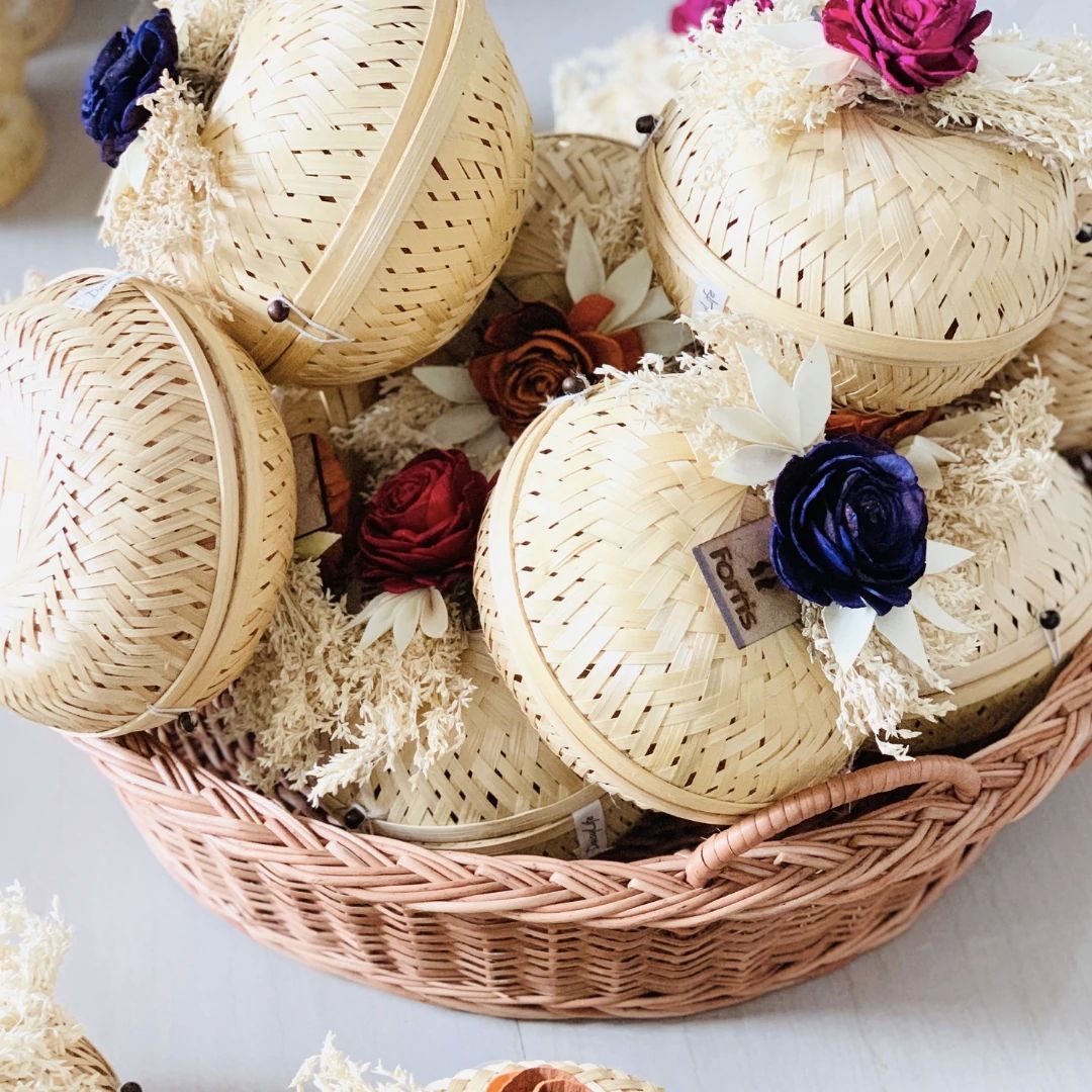 Natural bamboo gift basket with dried flower bow for gift packaging.