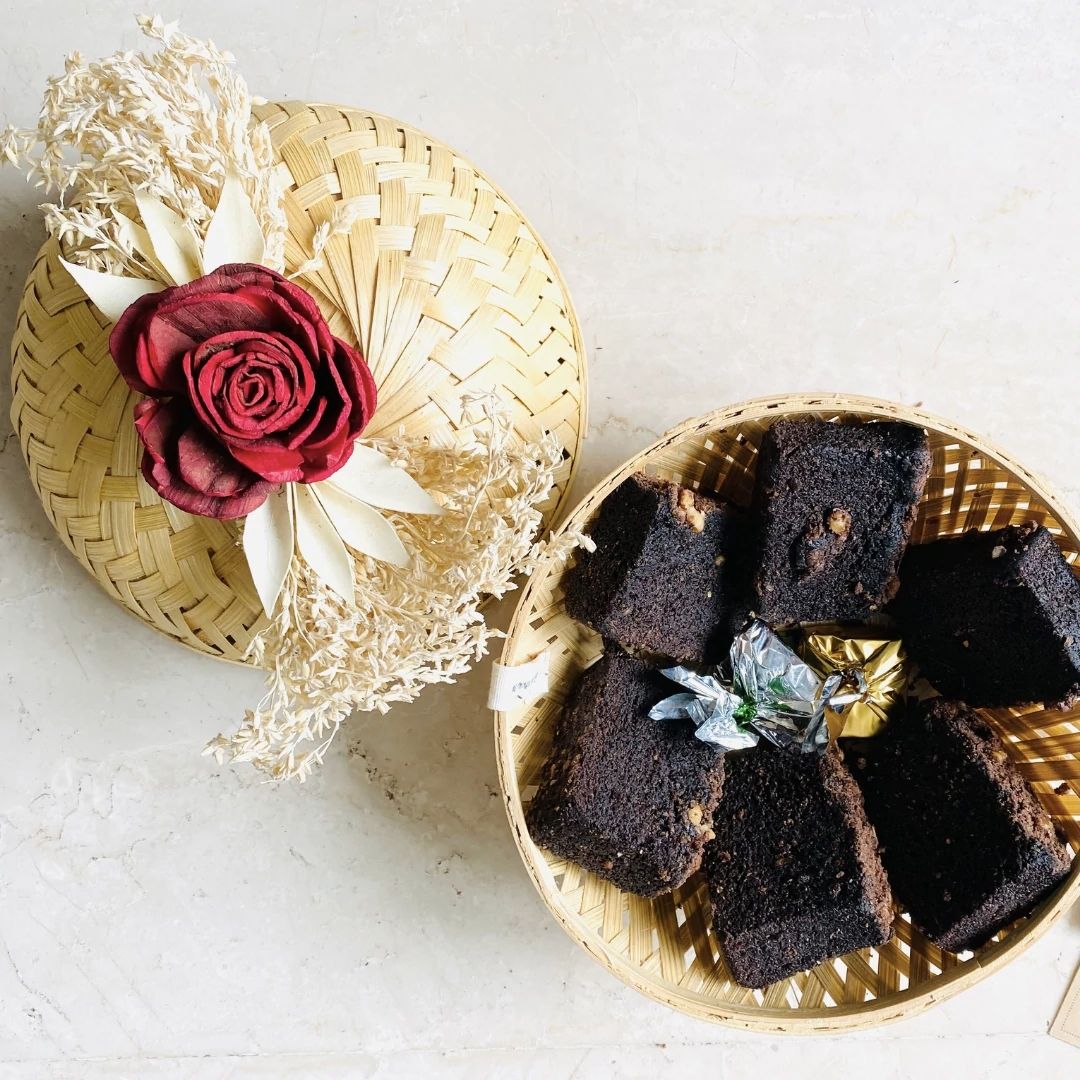 Natural bamboo gift basket with dried flower bow with brownies inside.