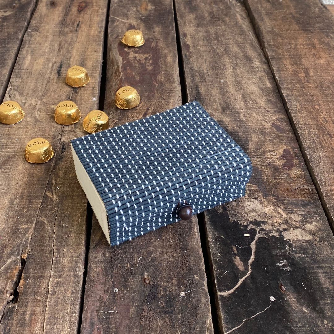 Grey gift box with chocolate in background