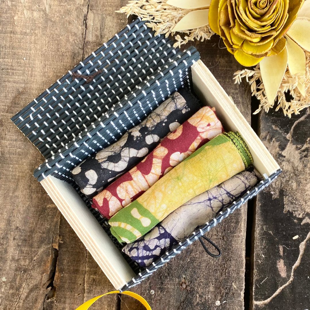 Napkins inside Grey gift box with flower in background