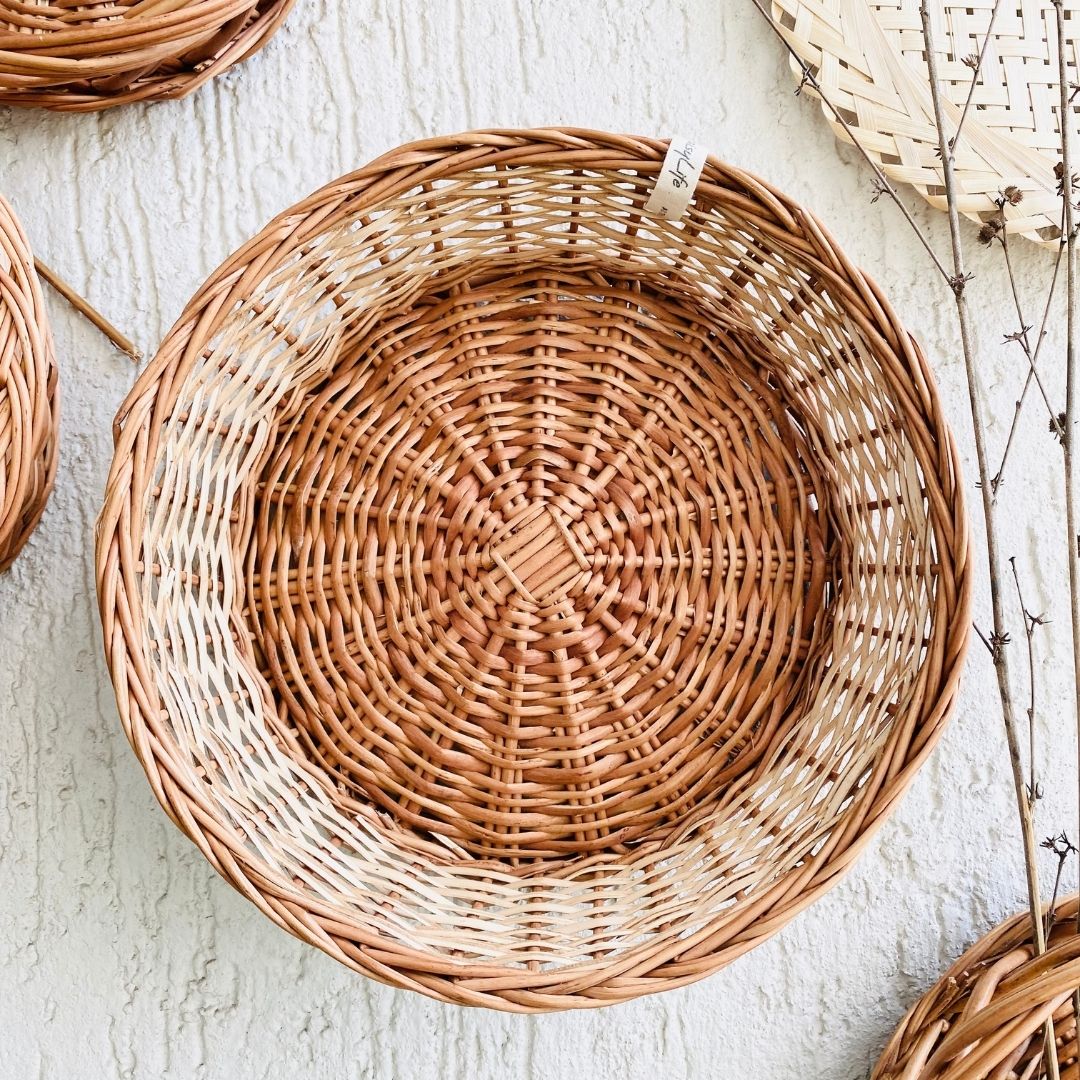 Round  wicker basket used in wall basket arrangement.