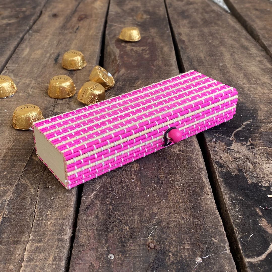 Pink gift box and chocolate kept in background