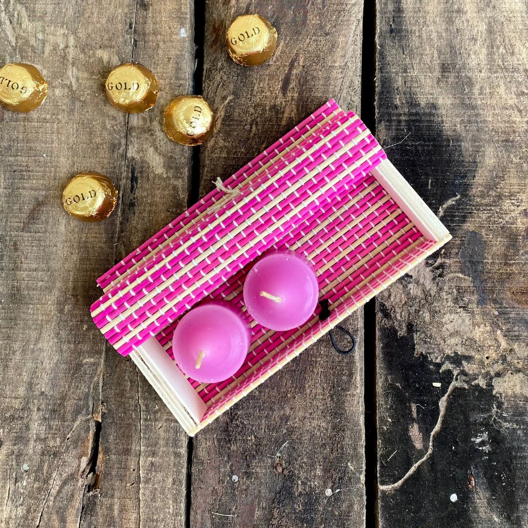 Pink gift box and chocolate kept in background