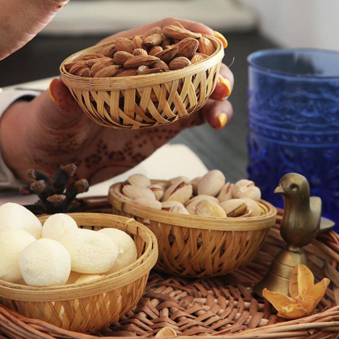 Almonds kept inside Simple, round, natural multi-purpose bamboo basket