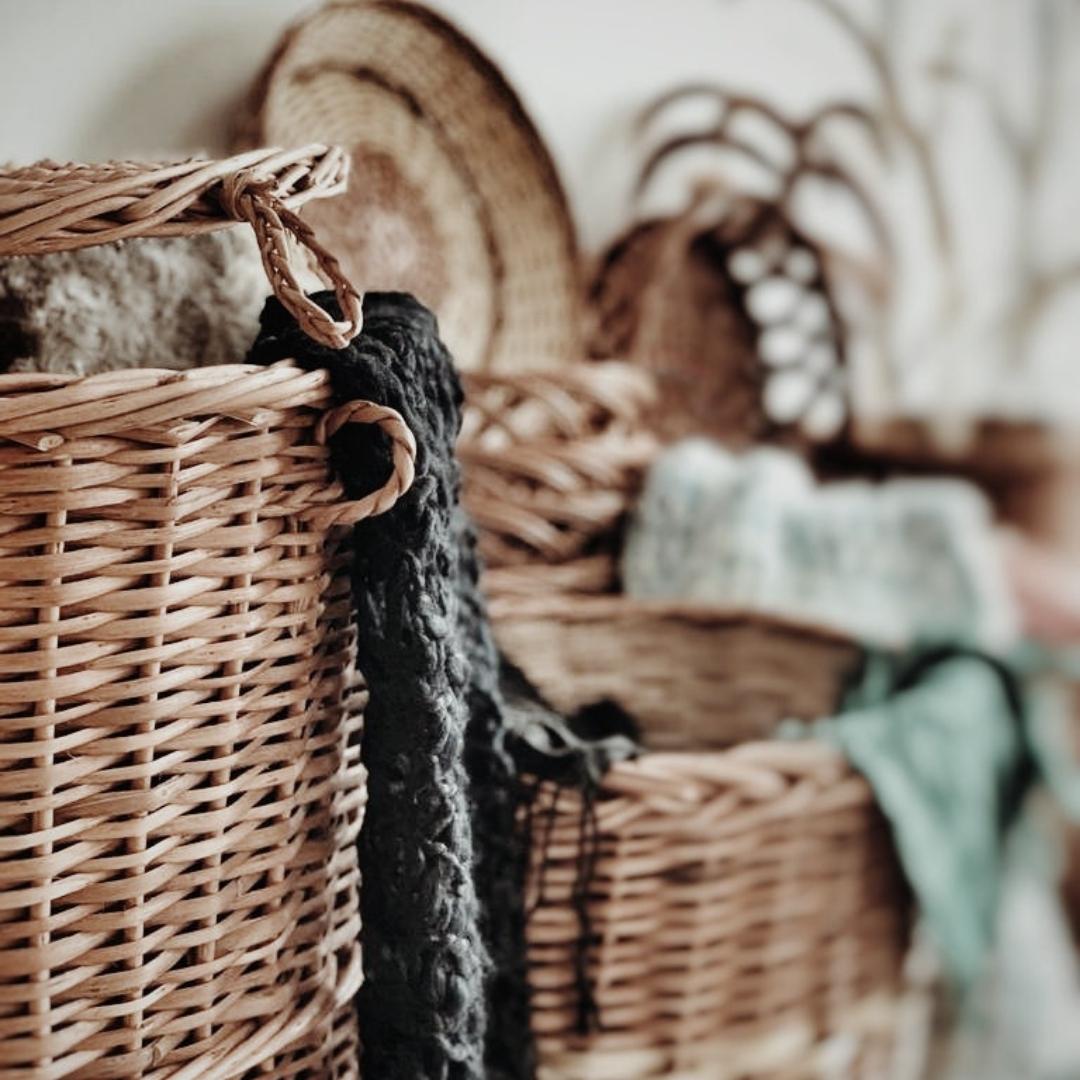 Cloths inside Willow wicker laundry baskets. 