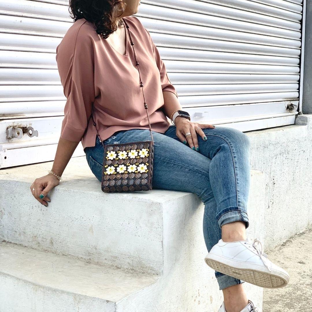 A girl carrying a neat flat passport shape in a sling to carry around easily or pack in travel bag