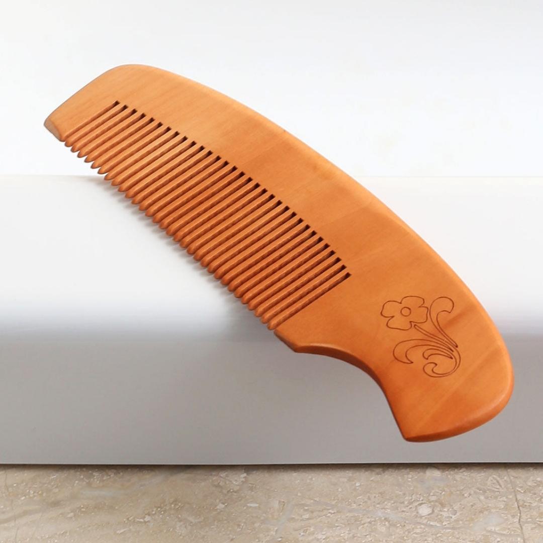 Light wood comb with pretty flower engraving in two different styles