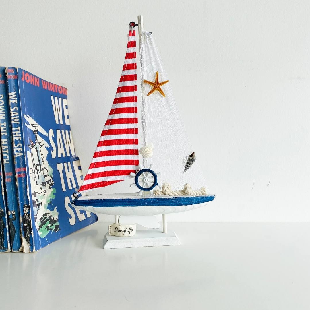 Wooden Natural coral/Seashell ship with red flag , books in background