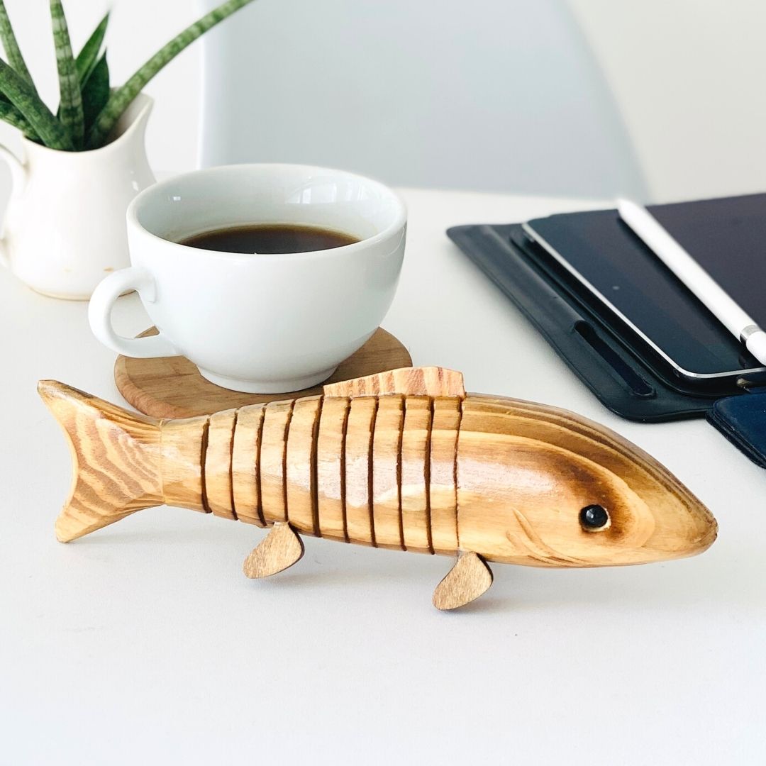 Close up of "Bubbles" Wooden Fish with tea in background.