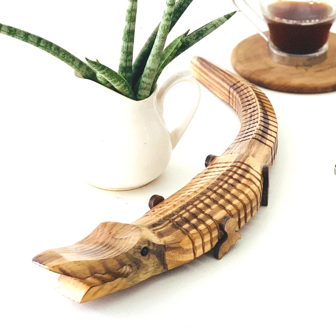 "Jaws" Wooden Alligator use as a work table accessory plant in background 