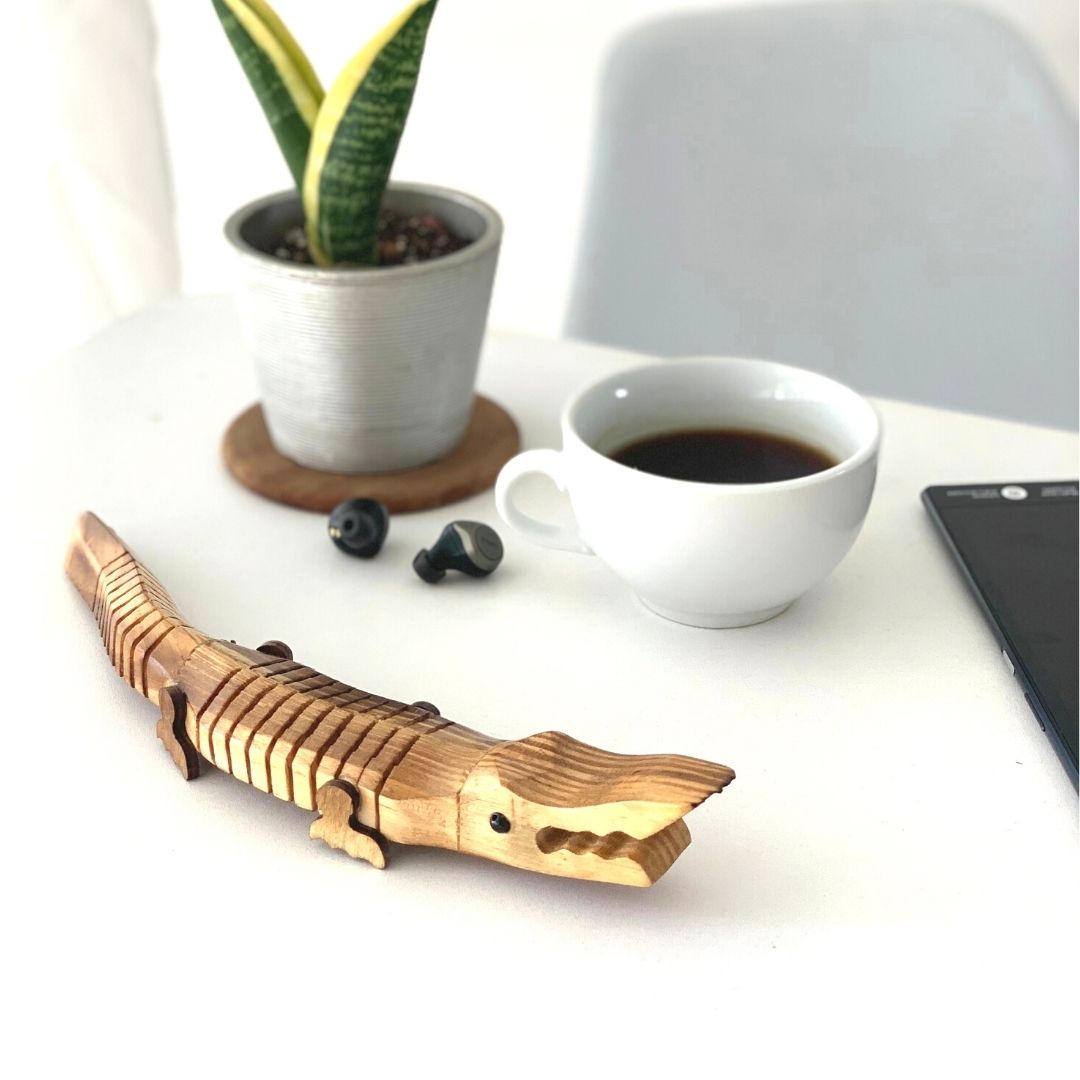 "Jaws" Wooden Alligator use as a work table accessory plant in background