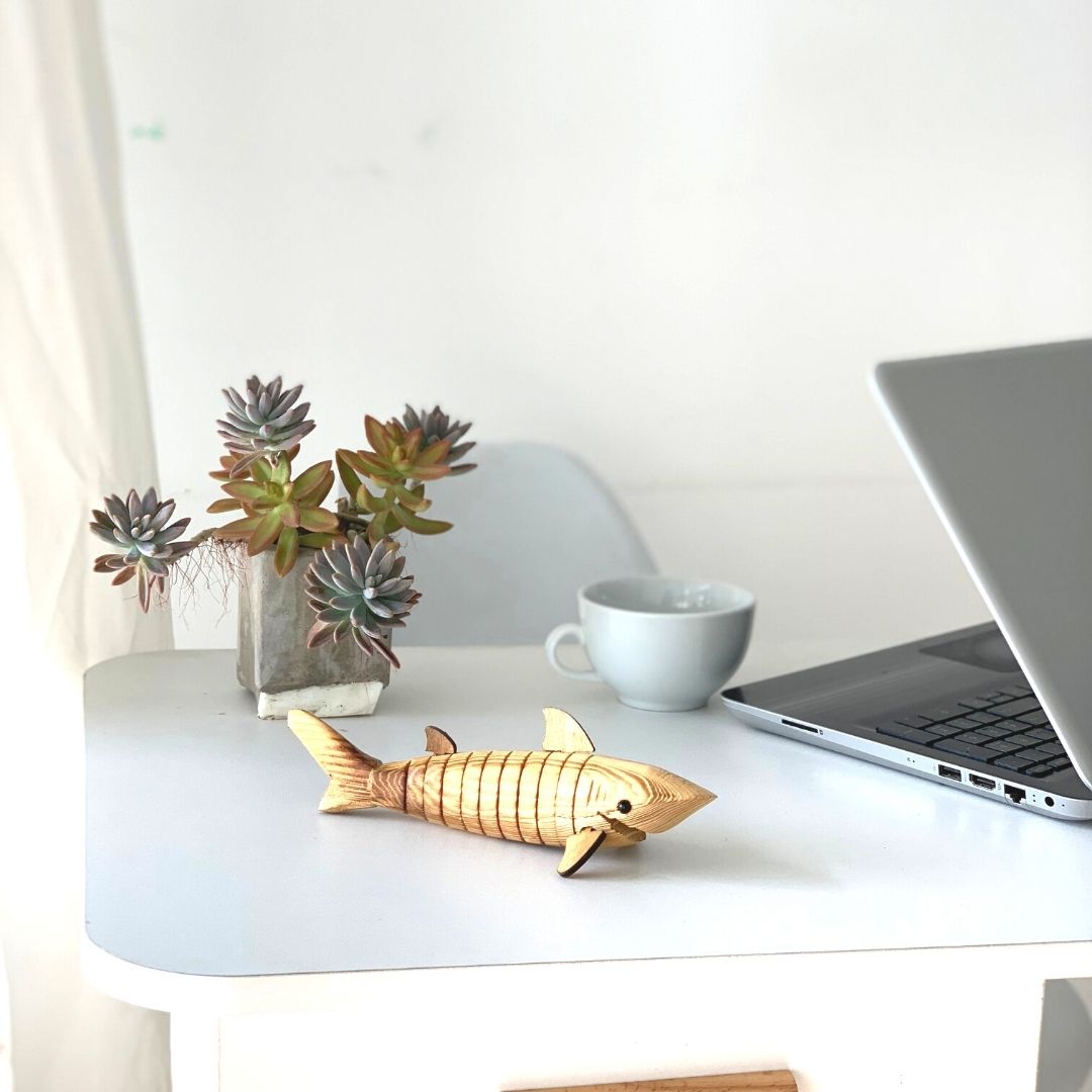 Wooden shark kept on the table as office room decor